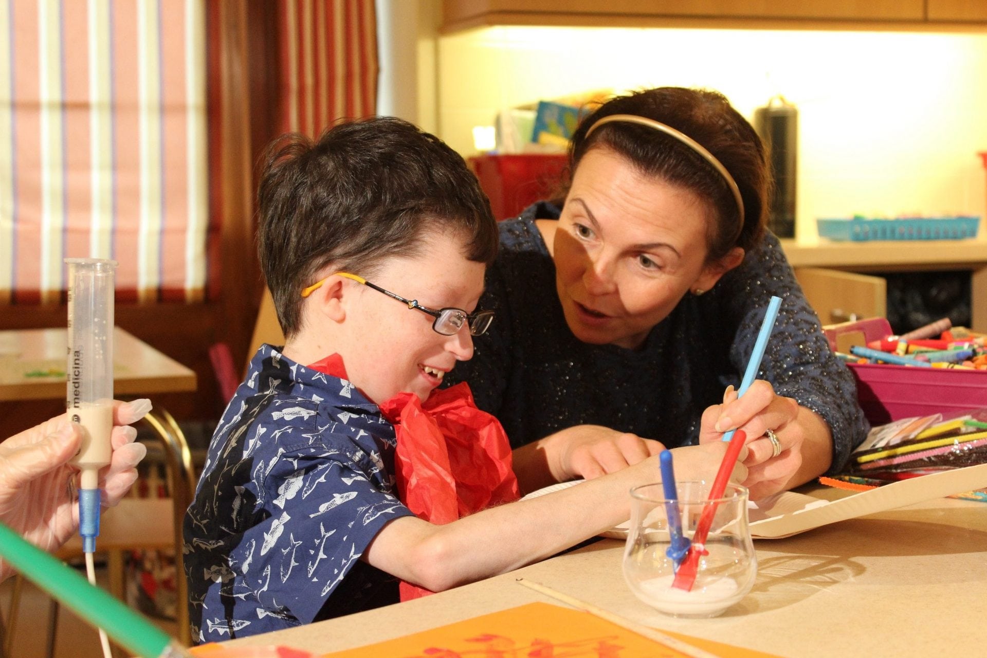 Young person draws while having a feed