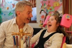 Child laughing with care team member Steve