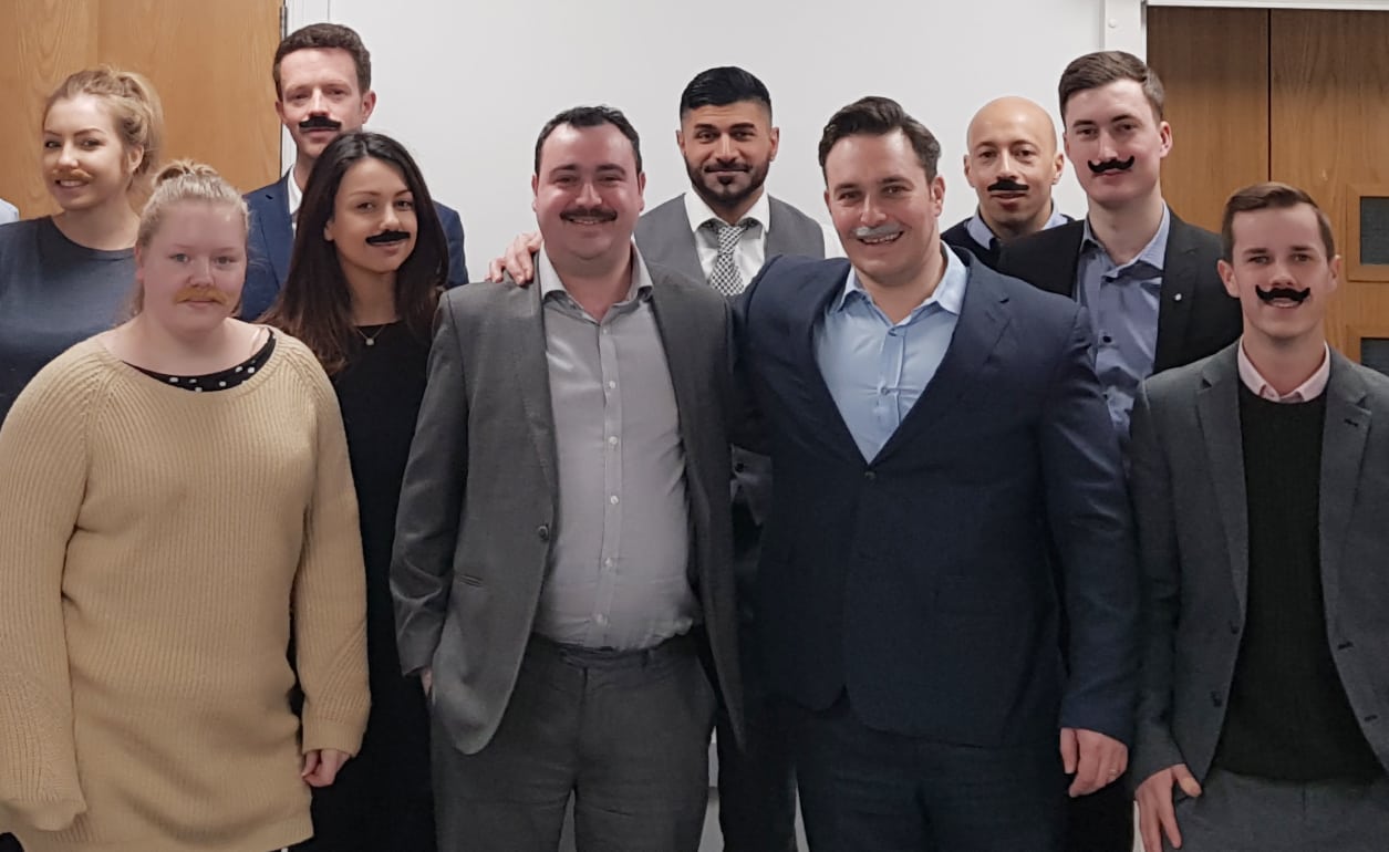 Staff at Interlink Recruitment wearing moustaches for Tash for Cash