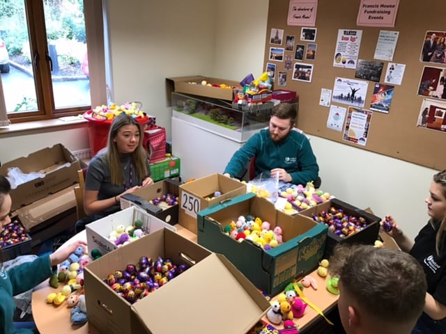 Volunteers from United Utilities filling knitted chicks with eggs