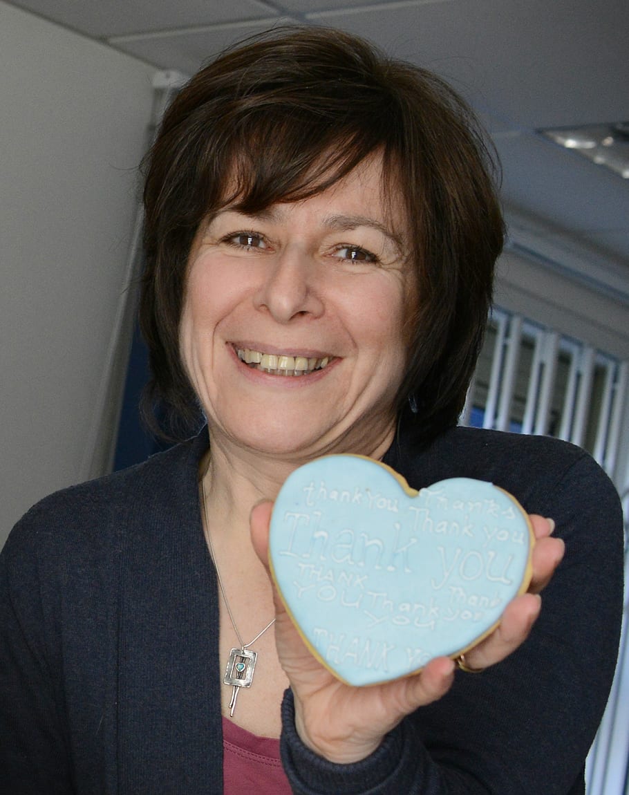 Michelle Jones holding a heart shaped cookie.