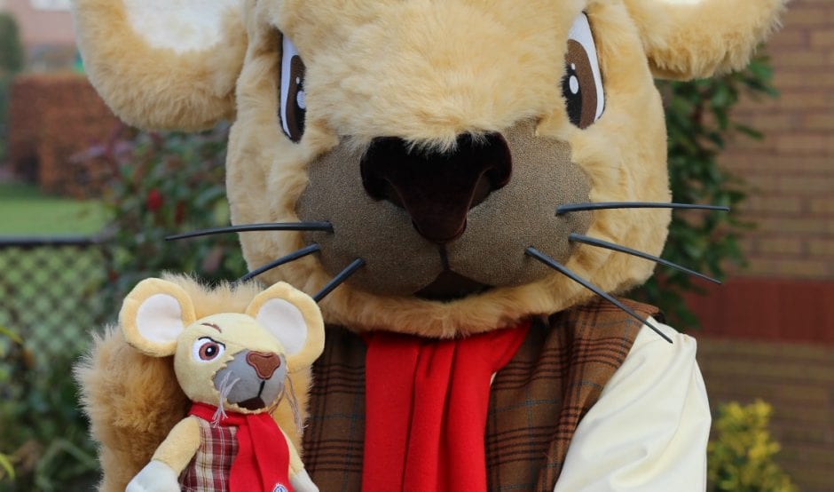 Francis Mouse holds mini mascot