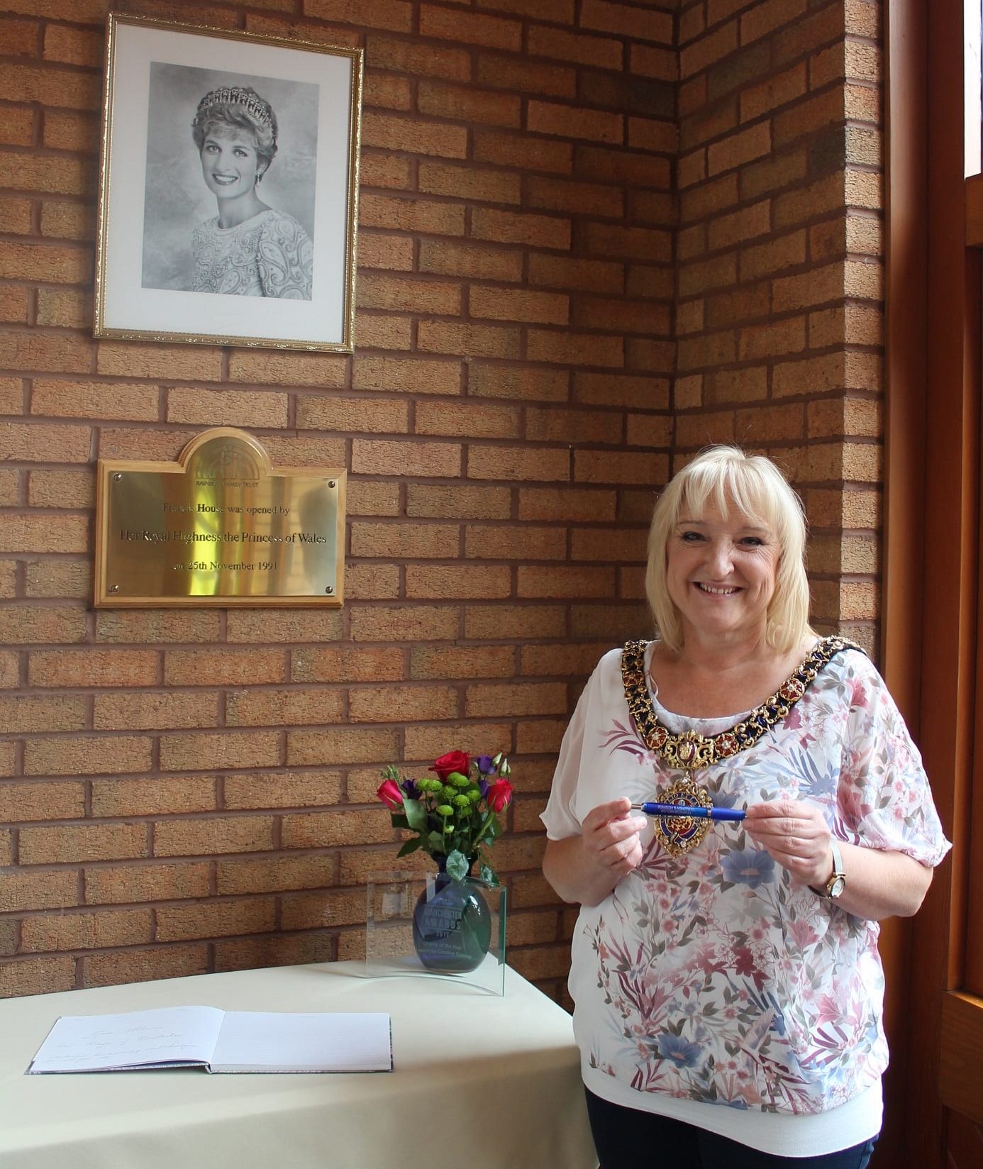 Lord Mayor stood by a plaque dedicated to the opening of Francis House by Princess Diana in 1991