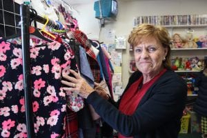 Shop volunteer sorts clothing racks