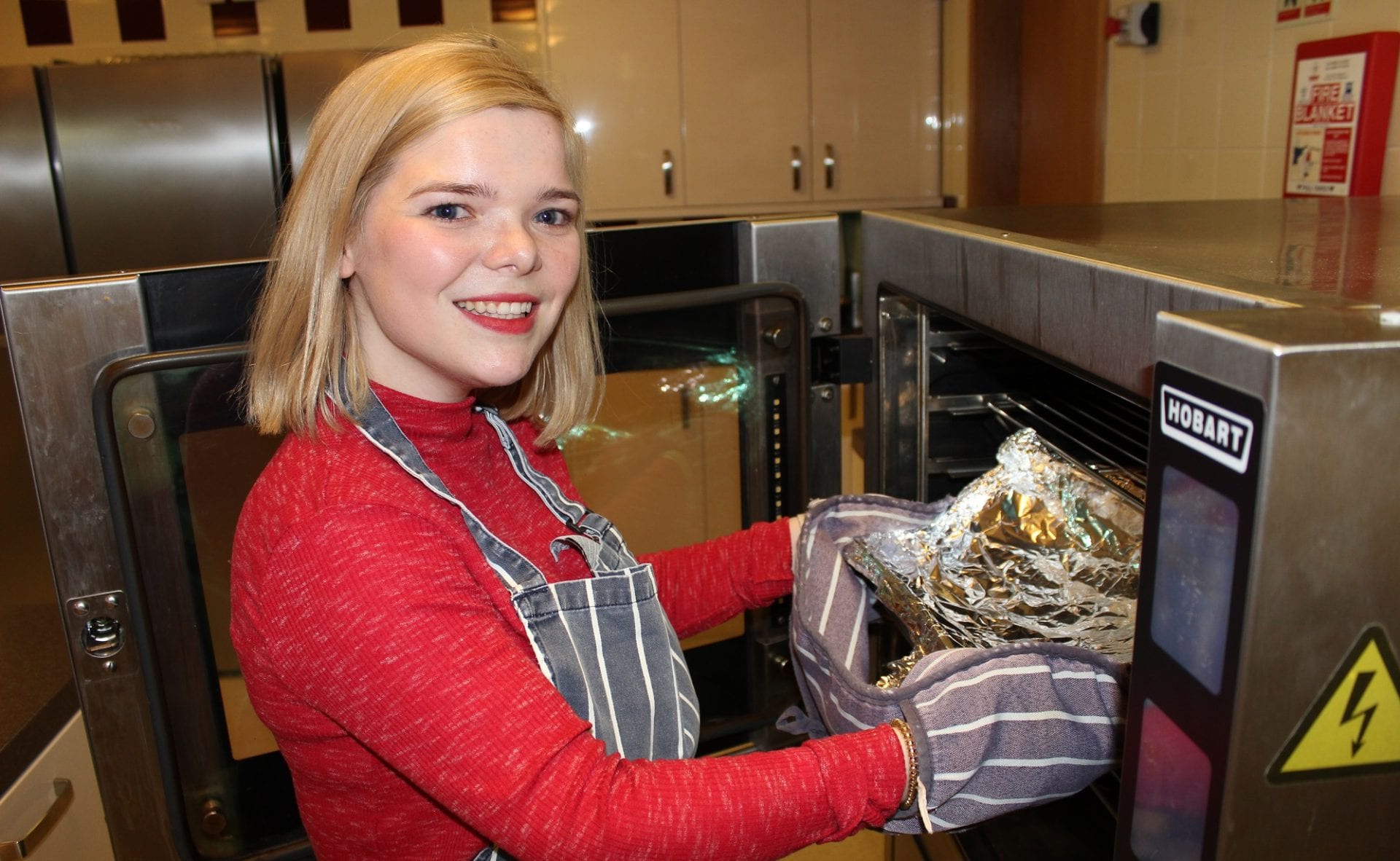 Nicky prepares hot food in the Francis Lodge kitchen