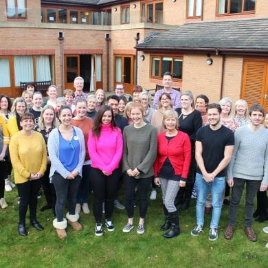 Francis House care team on the lawn outside Francis Lodge