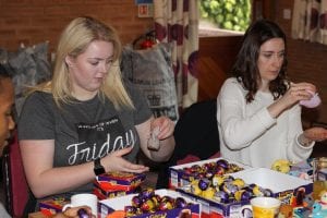 Barclays staff checking knitted chicks hold eggs