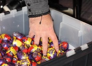 Hand grabs handful of creme eggs