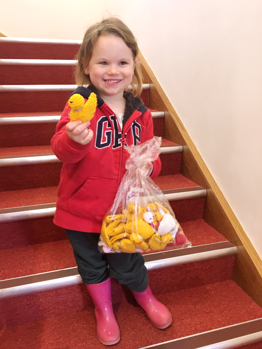 Alicia with chicks knitted by her mum and grandma knitted chicks.