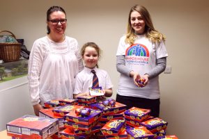 Helen and Lucy donating creme eggs to Rachel at Francis House.
