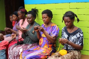 Knitters in Uganda knitting chicks for Francis House. Image Soft Power Education