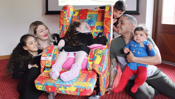 Family in the cinema room at Francis House.