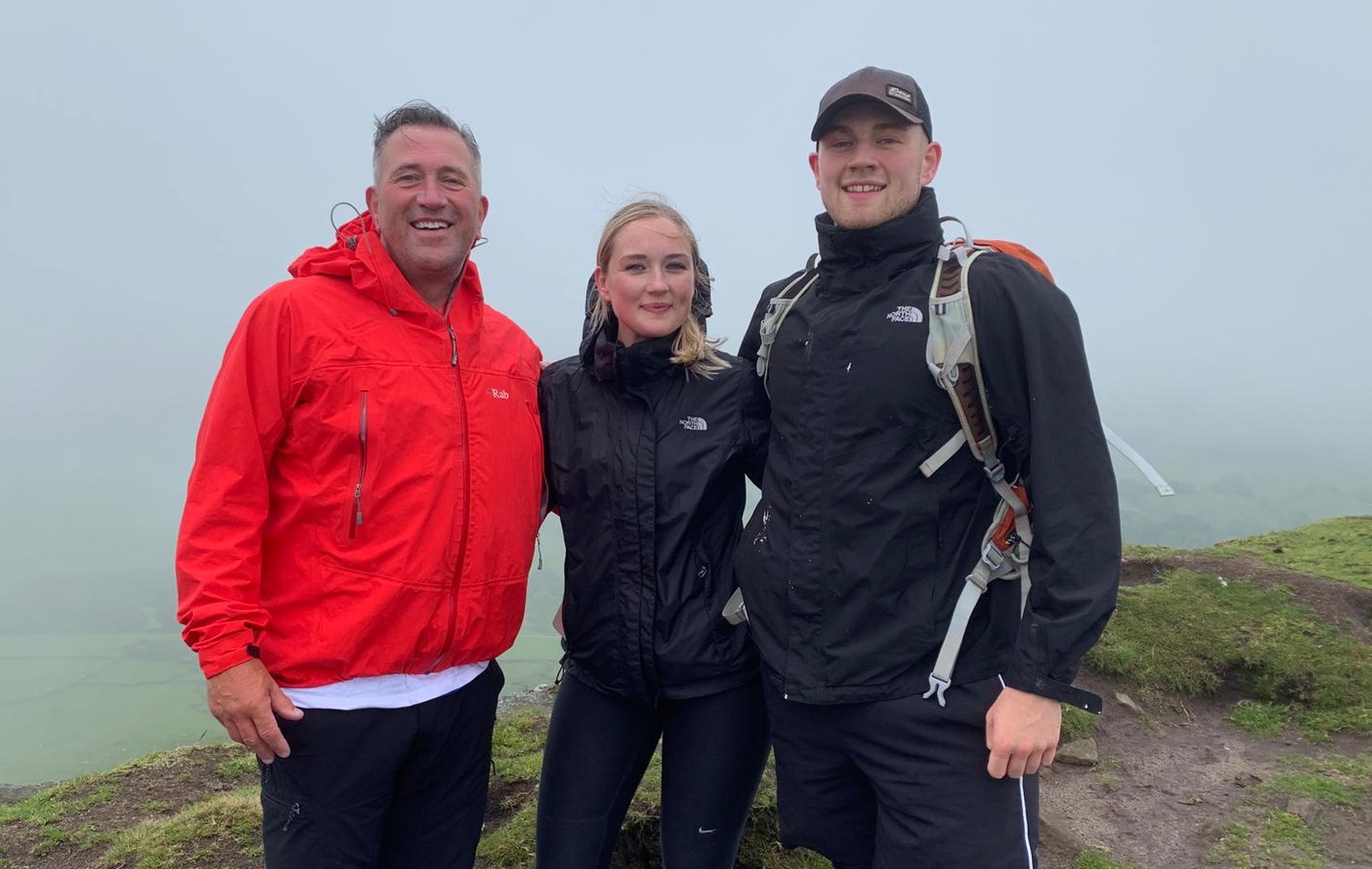 Three walkers in the cloud and rain in Cheshire