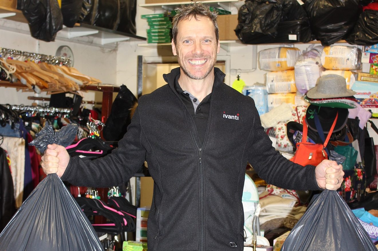 Man holding bags of charity donations