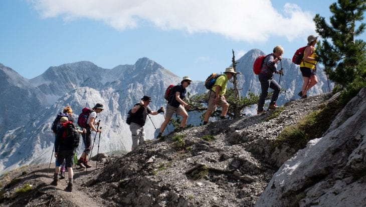 People trekking up mountains