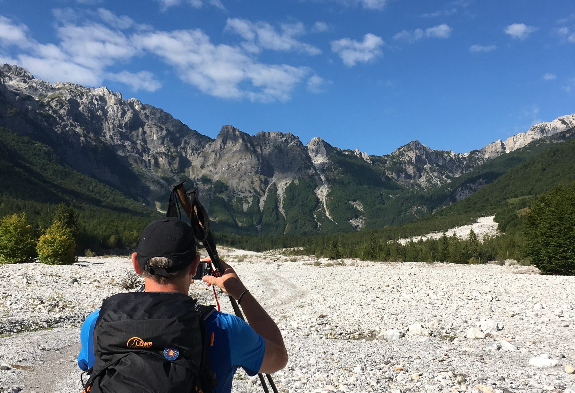 Man photographing view to Valbona Pass