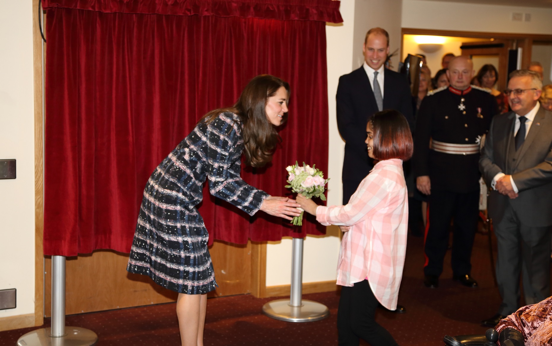 Duchess of Cambridge receives flowers from young person at Francis House