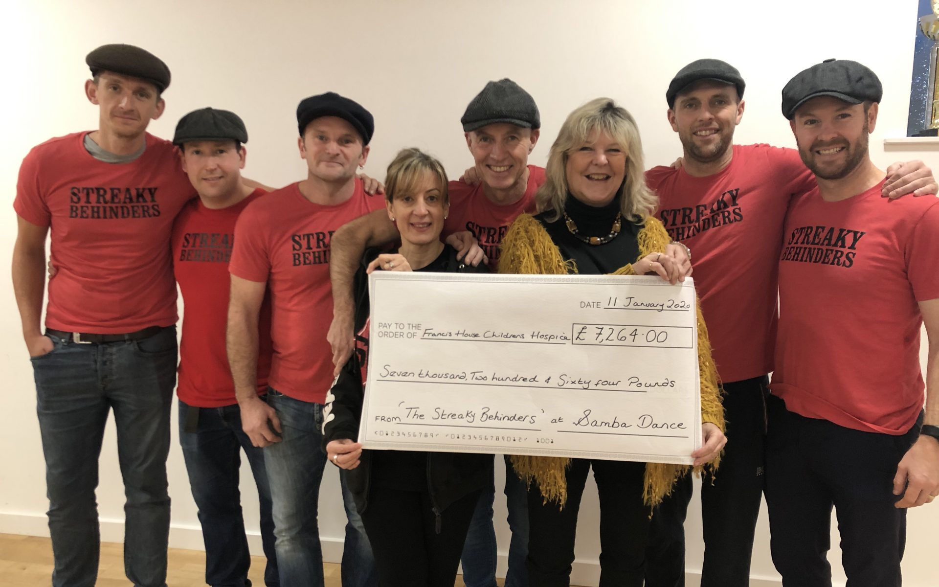 The dance dads present a cheque to Kate Puc