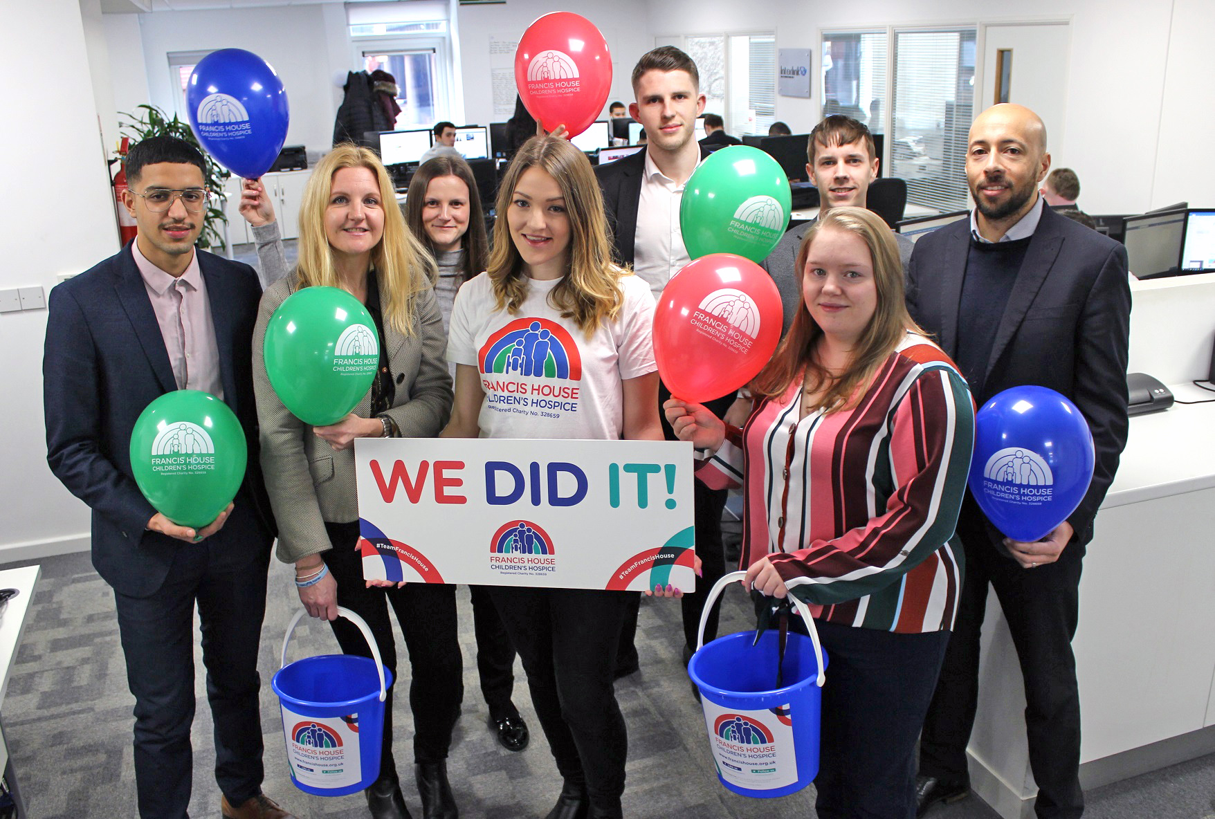 Staff with charity buckets and balloons