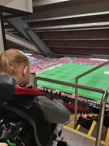 Young person looking at football pitch