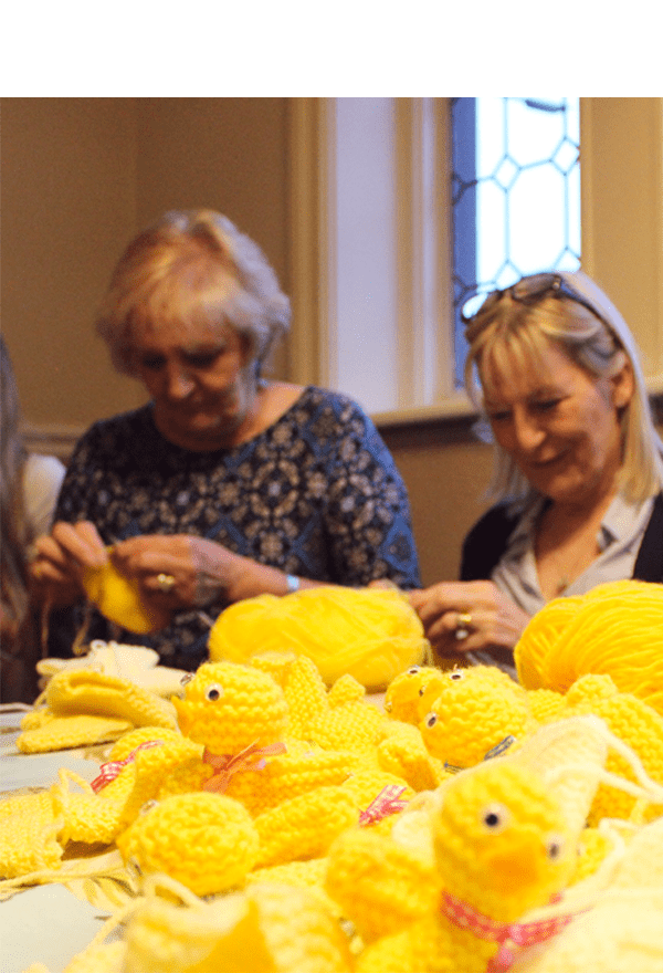 Ladies knitting Easter chicks for Francis House