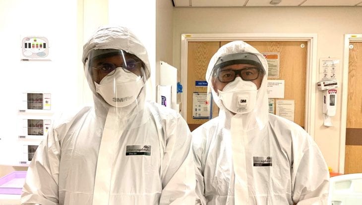 L-R Registar Dr Nevan Meghani and Georges Ng Man Kwong in full PPE taken during peak of Covid admissions