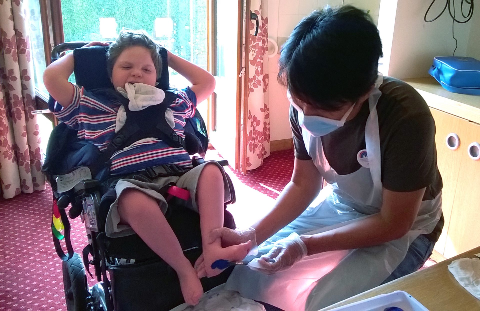 Child smiling having feet painted