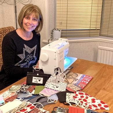 Tracey Sutherland sat at sewing machine making face coverings