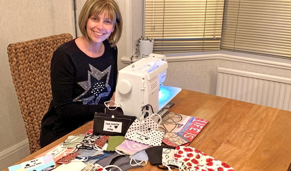 Tracey Sutherland sat at sewing machine making face coverings