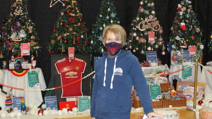 Julie Williams stood infront of Christmas trees