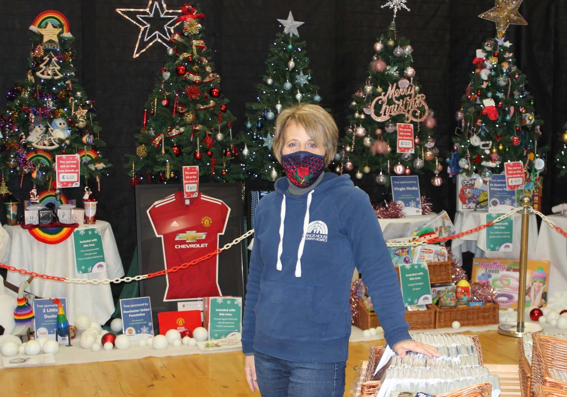 Julie Williams stood infront of Christmas trees