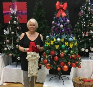 Woman stood by Christmas tree