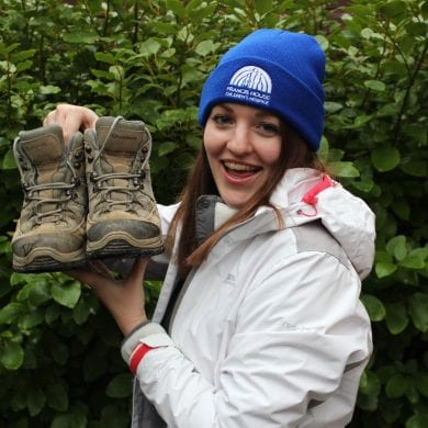 Rachel Astill holding up walking boots