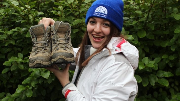 Rachel Astill holding up walking boots