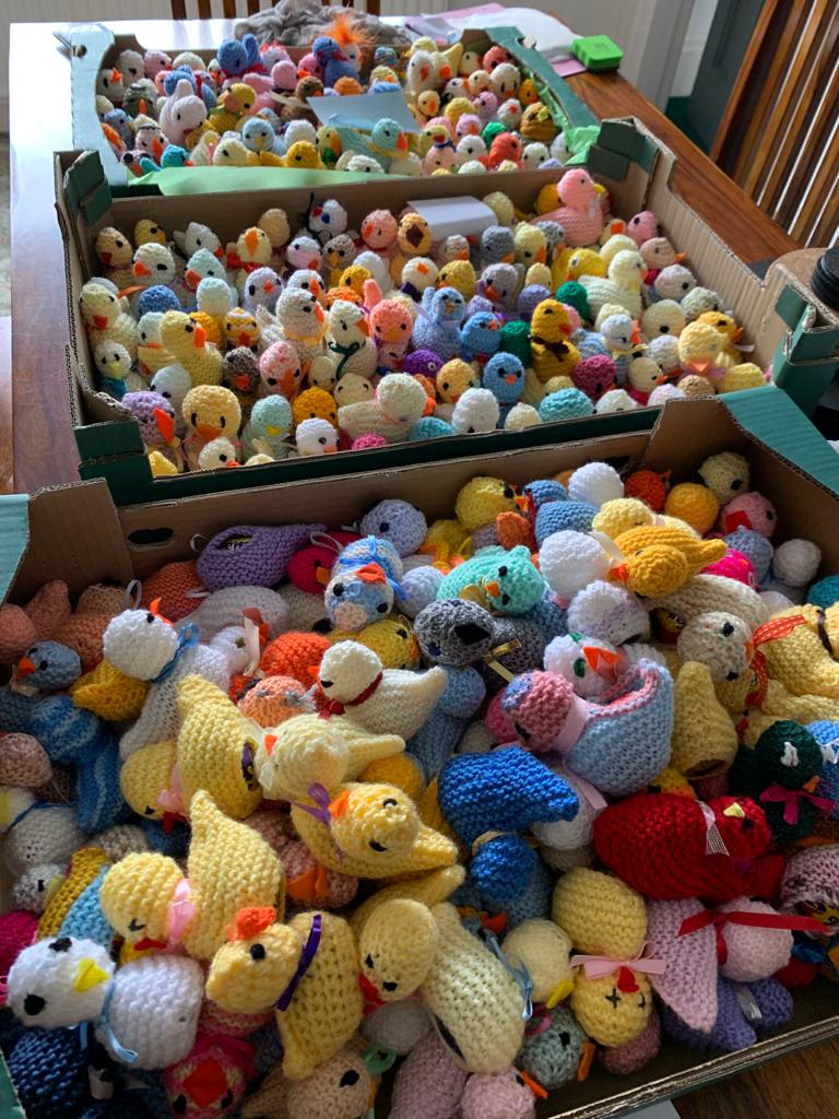 Boxes filled with knitted chicks