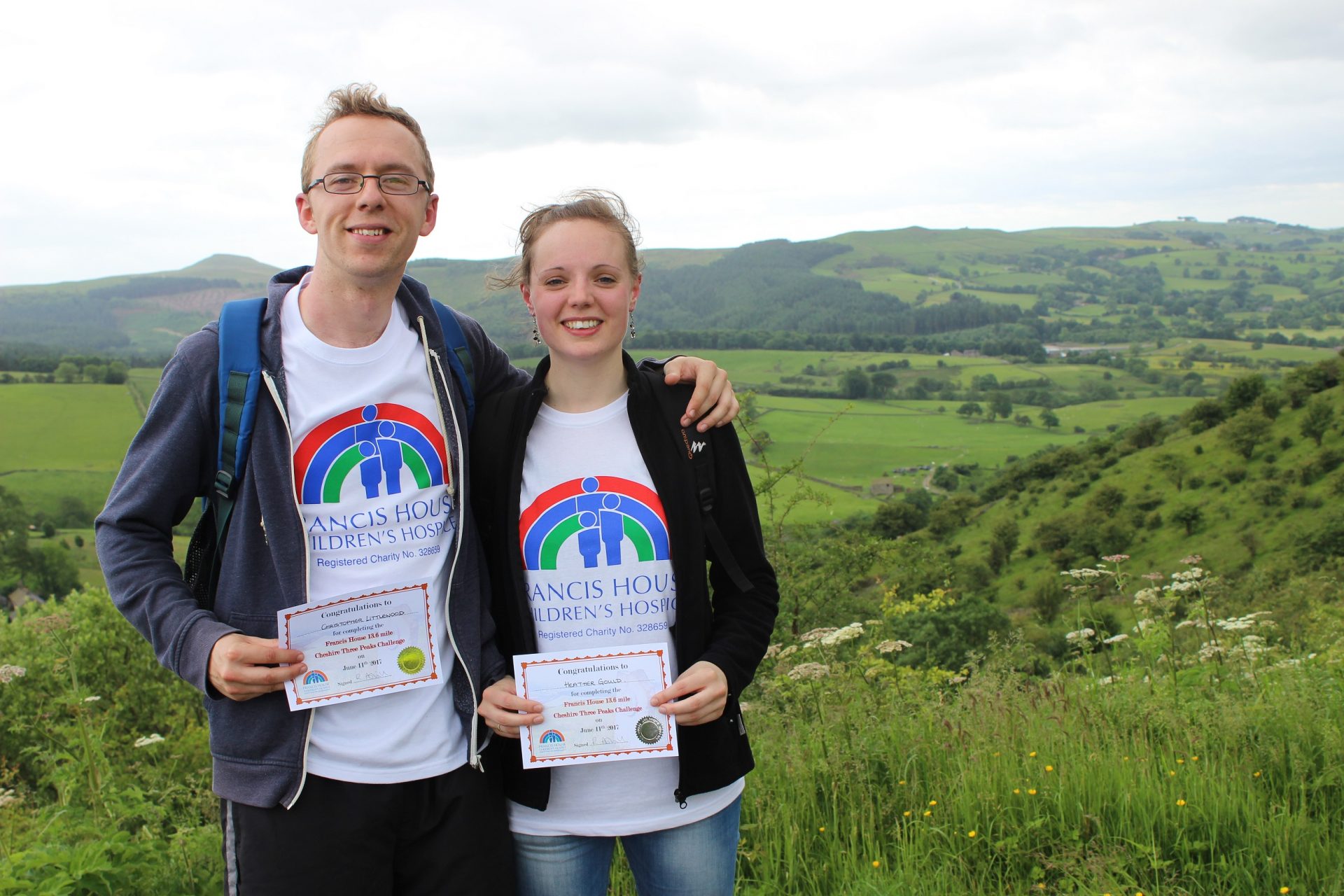 Two people holding certificates after completing the Cheshire Three Peaks challenge