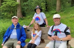 Family sat on bench in forest