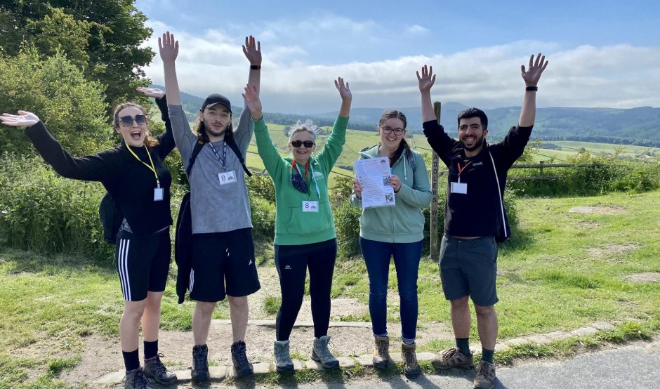 Group of people outside with hands in the air