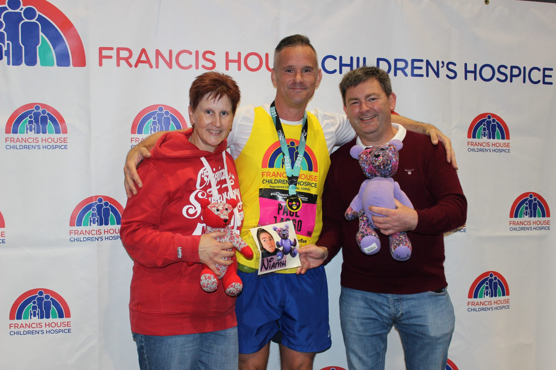 Couple with man in Francis House running gear at the Great Manchester Run