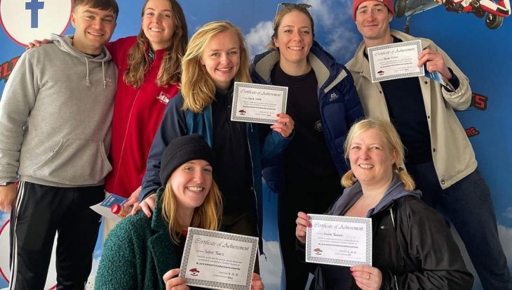 Hallidays sky diving team holding certificates