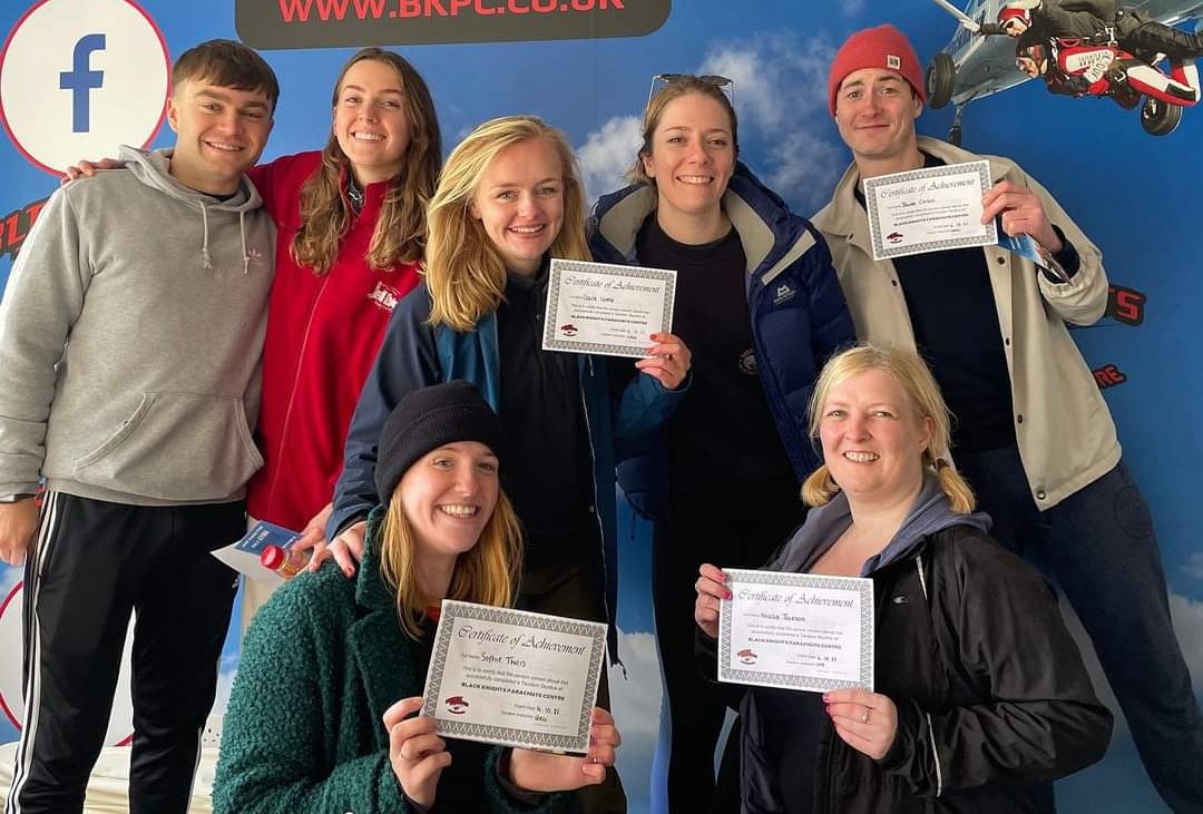 Hallidays sky diving team holding certificates