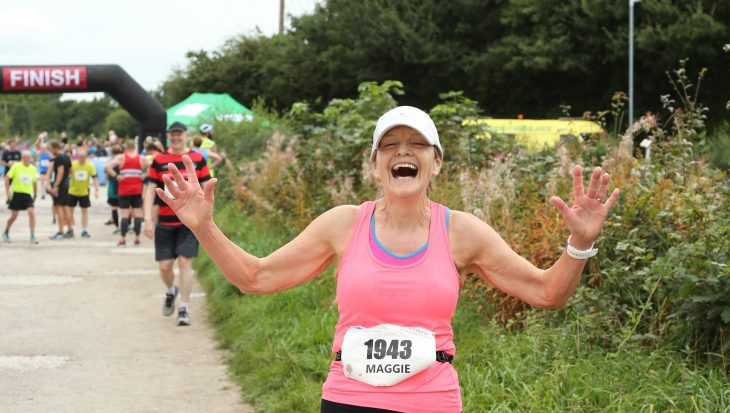 A runner celebrates at the Wilmslow Running Festival