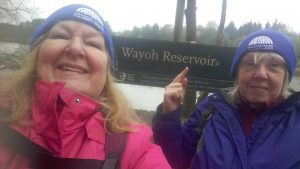 Two women stood in front of reservoir sign