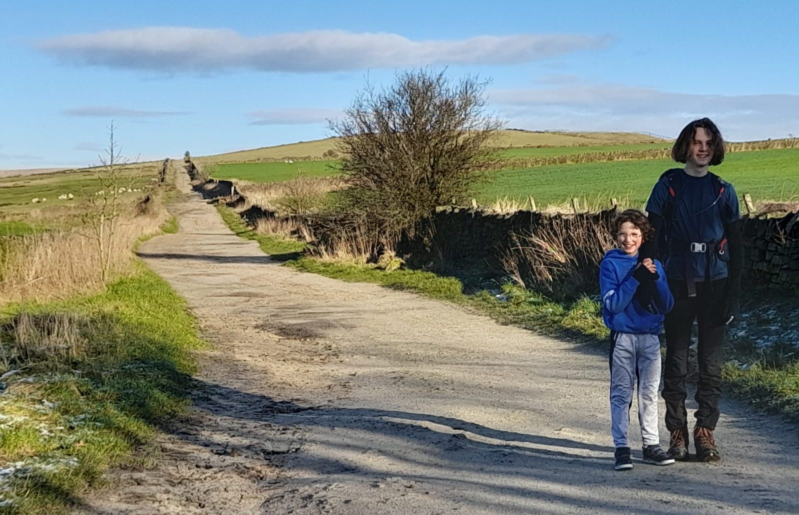 Two boys walking down a country lane