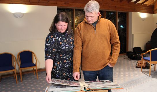 Jayne and Darren Brockbank looking at a photo album