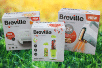 Boxes of Breville kitchen appliances on a grass background