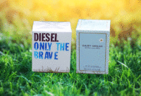 Two boxes of perfume on a grass background
