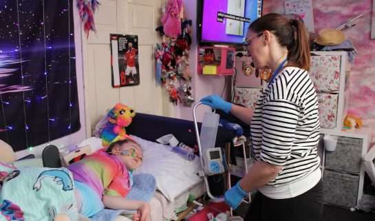 Homecare team nurse Alison giving child water through a tube