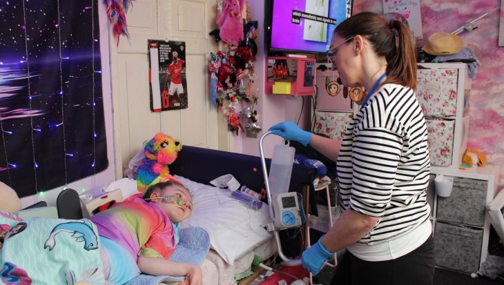 Homecare team nurse Alison giving child water through a tube