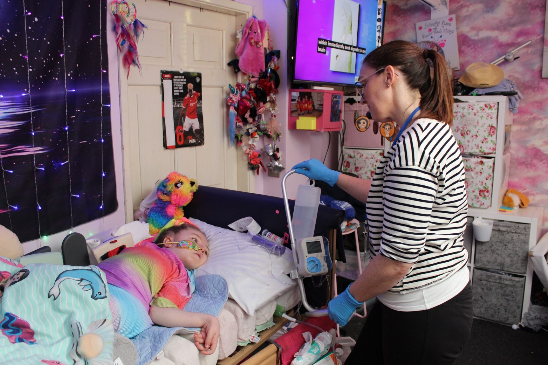 Homecare team nurse Alison giving child water through a tube